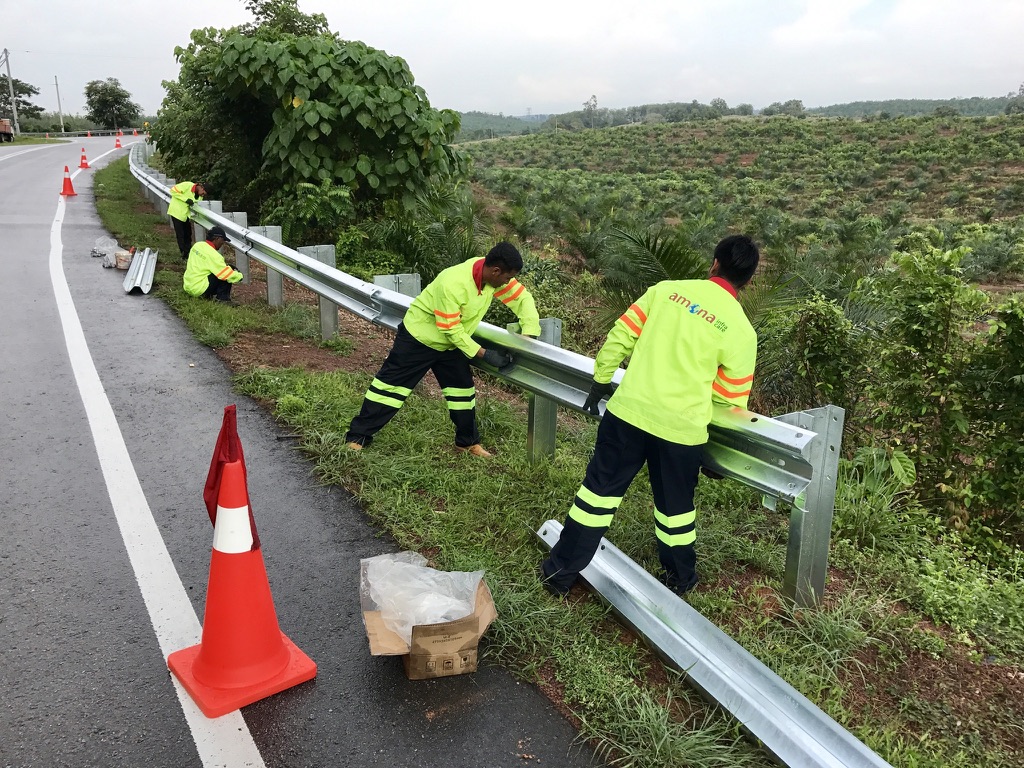 Crew working on roadside guardrail