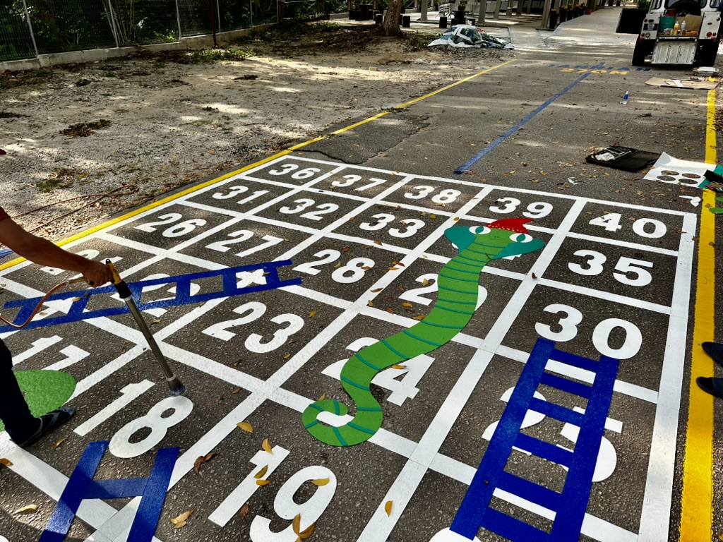 Colourful snakes and ladders ground markings with numbers